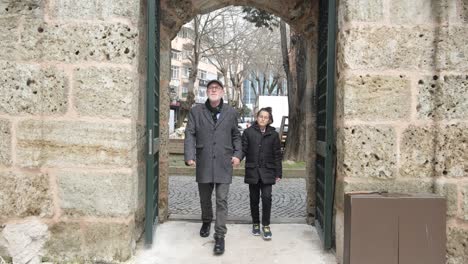 Man-and-child-in-mosque-courtyard