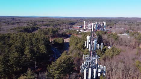 un dron aéreo de 4k orbita alrededor de una torre de telefonía celular en un suburbio boscoso