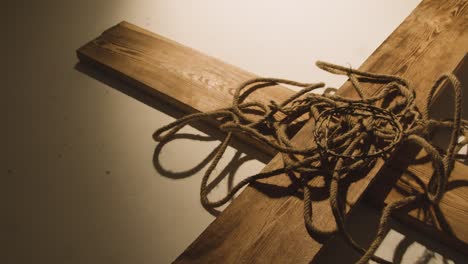 religious concept shot with crown of thorns rope and wooden cross in pool of light 3