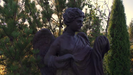 old rusty statue of an angel on a sunny morning in the cemetery