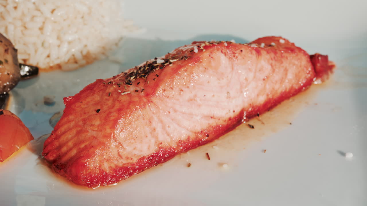 Close up shot of a freshly grilled salmon fillet seasoned with herbs