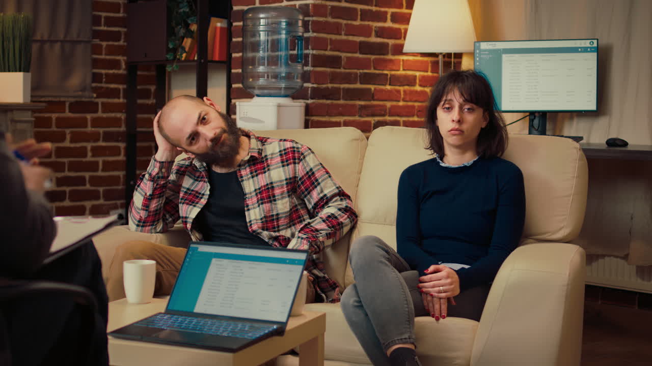 Portrait of unhappy couple attending counseling therapy session