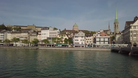 Walking-around-Zurich-Switzerland-old-town-center-filming-lake-and-beautiful-church-in-background