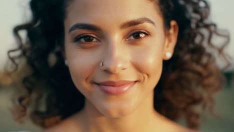 close-up portrait of a smiling woman with curly hair