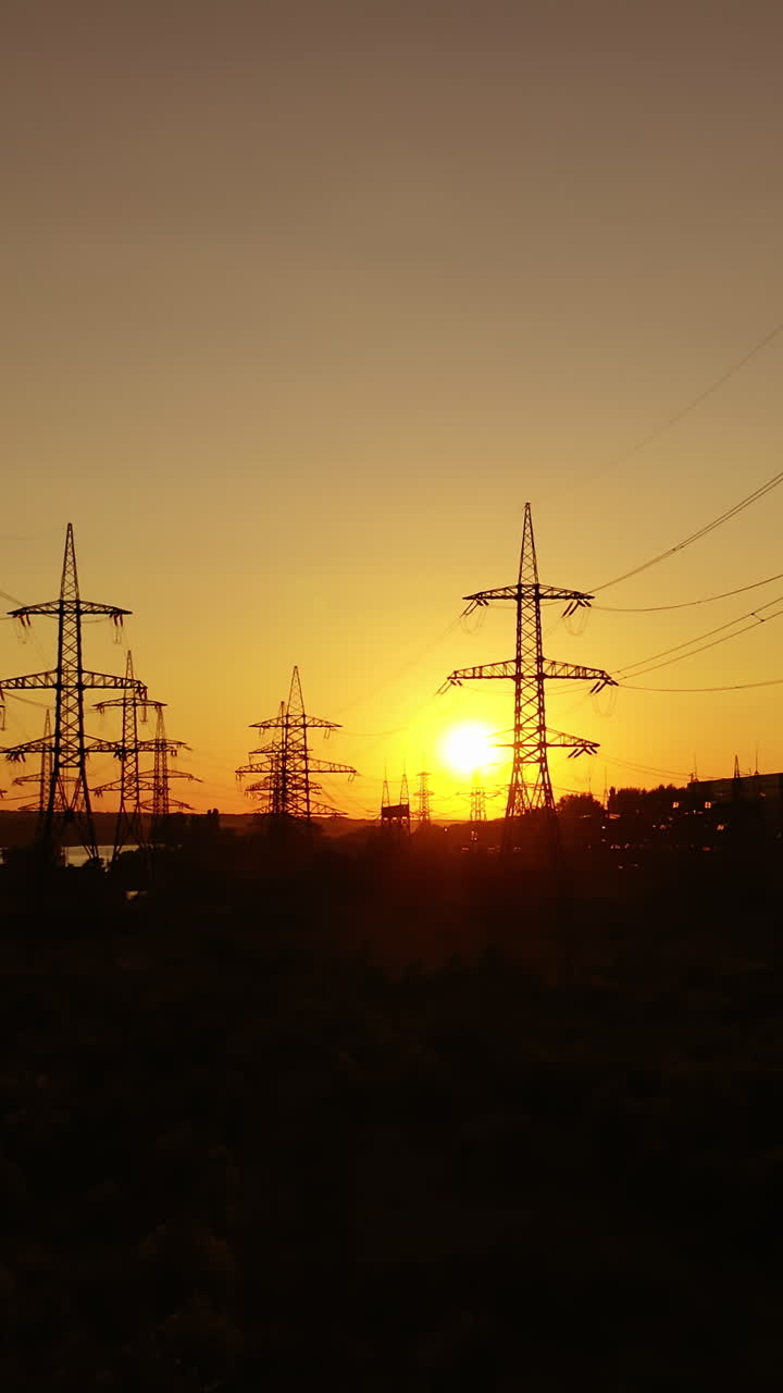 Electric tower of high voltage. Aerial view of high voltage power lines silhouette