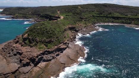 rugged landscape of wybung head lookout, frazer park, new south wales, australia - drone shot