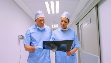 Surgeon-and-colleague-discussing-over-an-x-ray