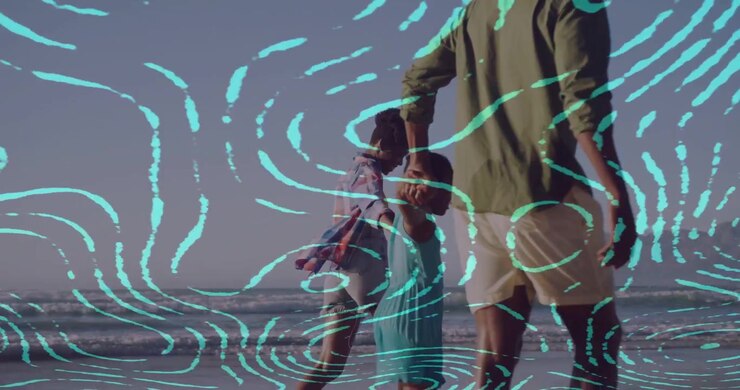 Vertical video: Walking family at beach, child in teal reaching up and adult lifting her, overlay