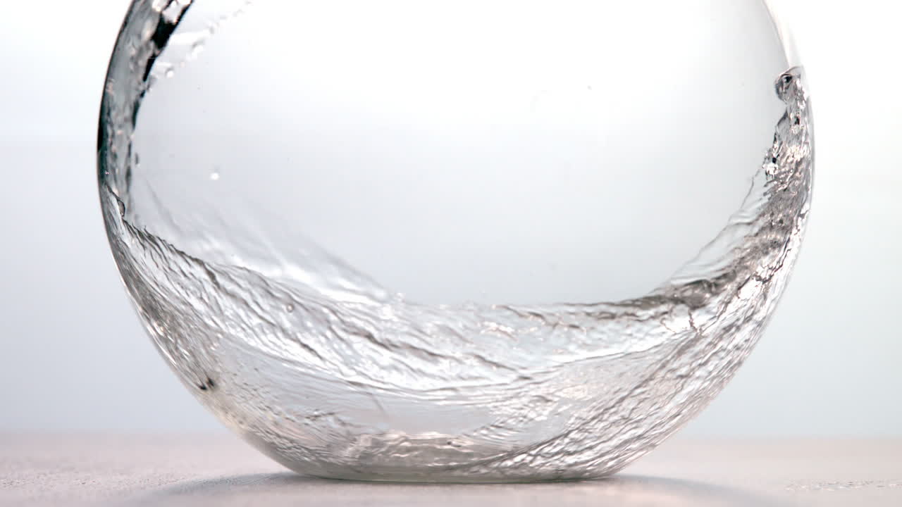 Water pouring into glass bowl