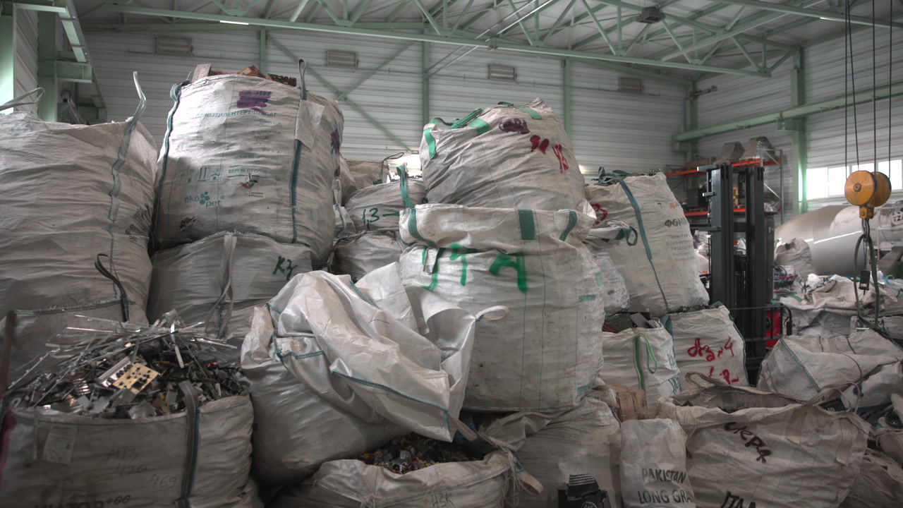 Towering Bulk Bags Near Forklift Bay, Bright Roof Trusses And Metal Beams, Forklift Operator Maneuvering . Media