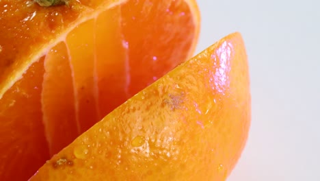 very sharp knife cutting a thic slice of tangerine