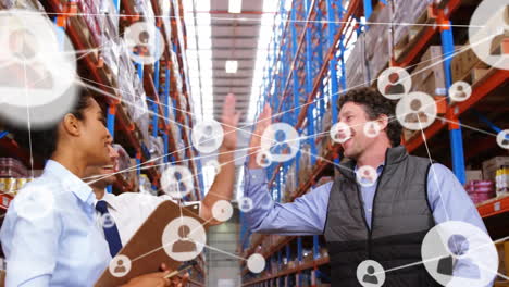 Animation-of-network-of-connections-with-icons-over-diverse-people-working-in-warehouse