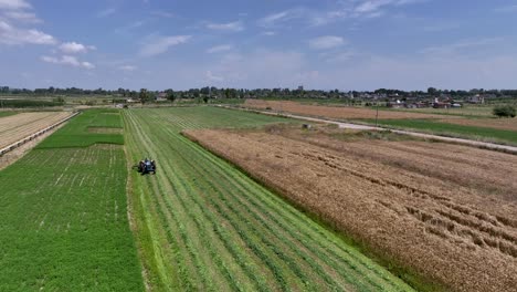 farmer working his farming land with a tractor during a hot summer day