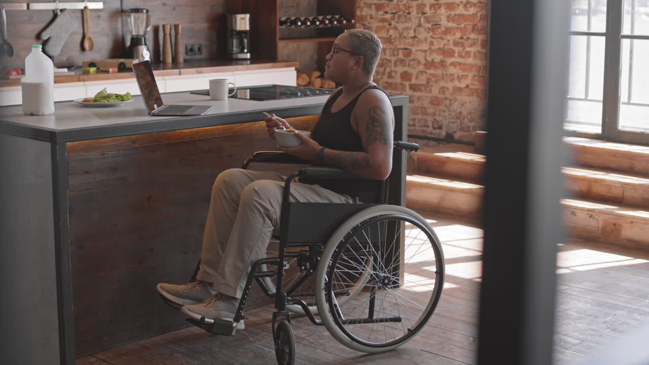 Woman in Wheelchair Eating Breakfast