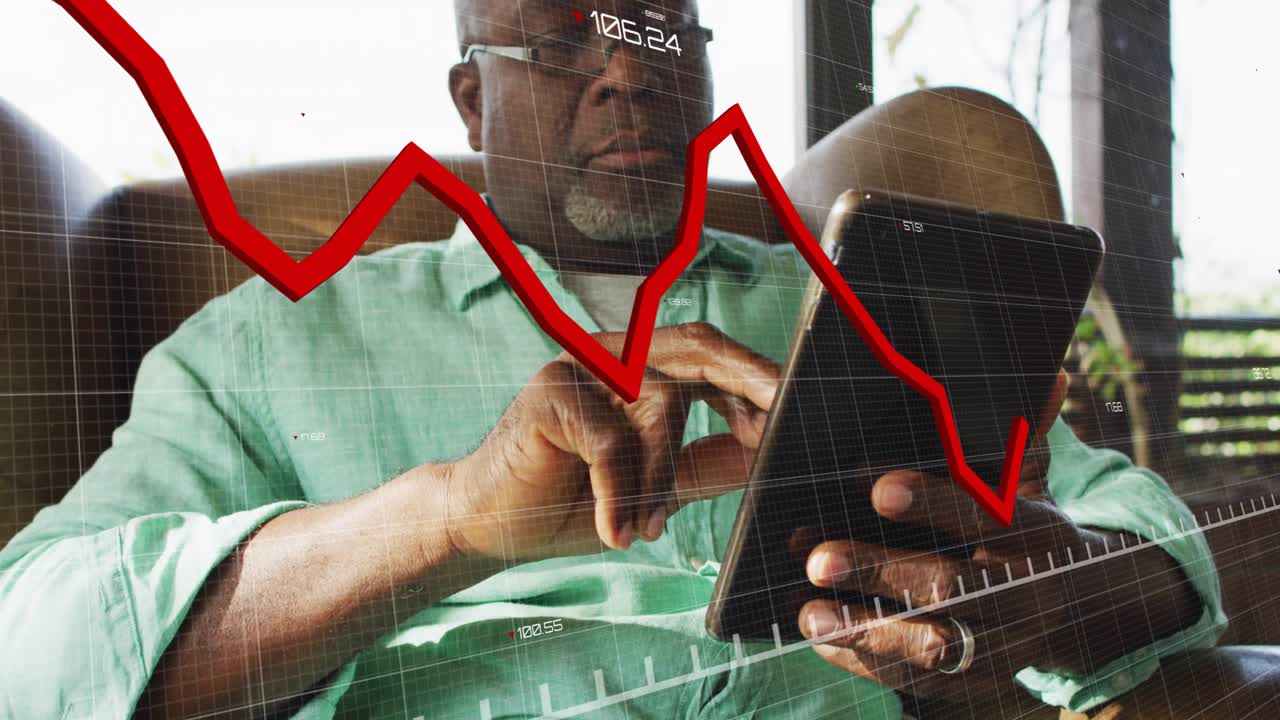 Senior man tapping tablet revealing grid, red finance chart tracking market trend downward, upward
