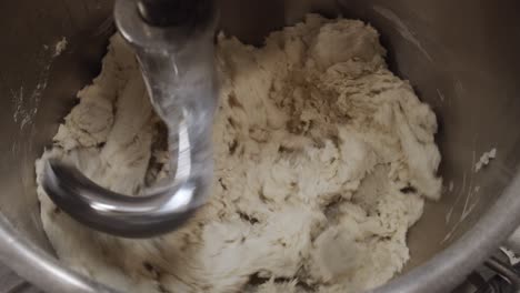 kneading the pizza dough in big kitchen mixer