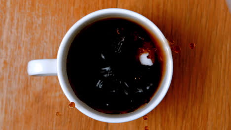 sugar cubes falliing into coffee cup