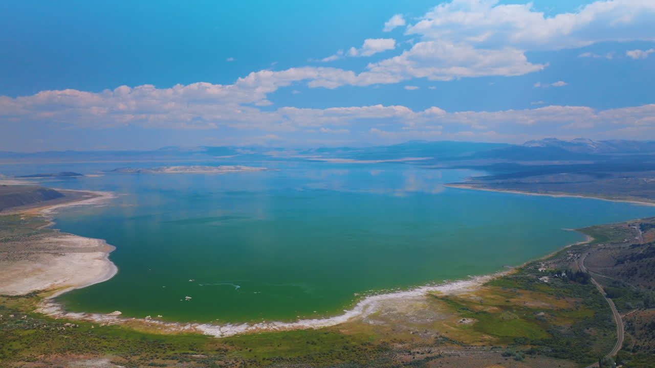 Mesmerizing turquoise scenery of lake joining with sky. Amazing saline soda Mono Lake in California from aerial perspective.