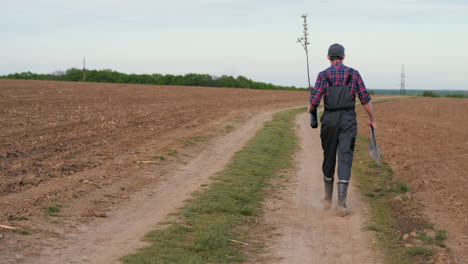 farmer planting a tree in a field