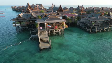 luxury wooden houses build on water in malaysia in mabul island, pan right