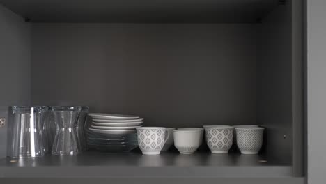 organized kitchen cabinet with cups and dishes