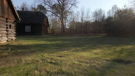 old wooden farm houses with spring green landscape