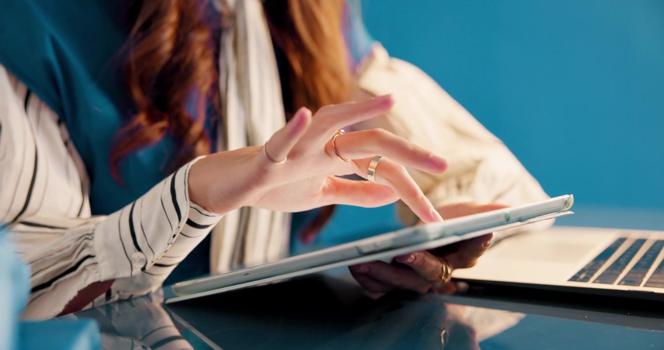 Woman Using Digital Tablet at Desk in Office