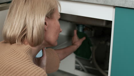 woman calling a plumber