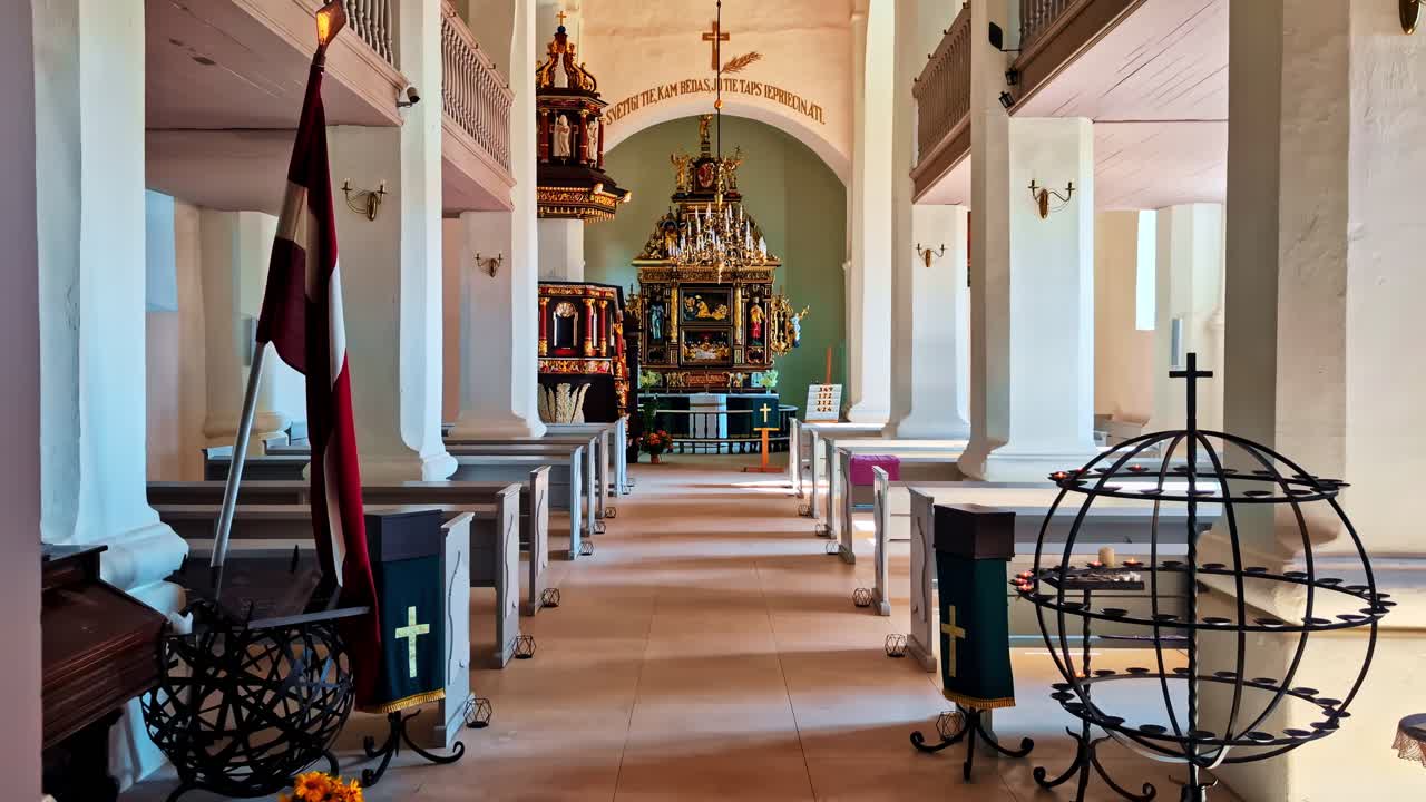 Interior of small ornate chapel with pews, gold details, and high vaulted ceiling