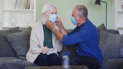 Senior-caucasian-couple-wearing-face-masks-at-home