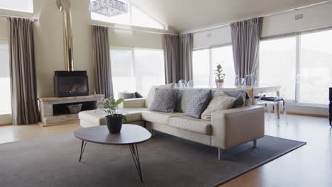 General-view-of-modern-living-room-with-fireplace-and-furniture-with-copy-space,-slow-motion