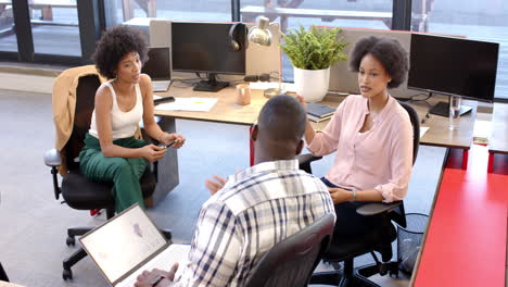 a diverse team of young professionals discussing project in modern office