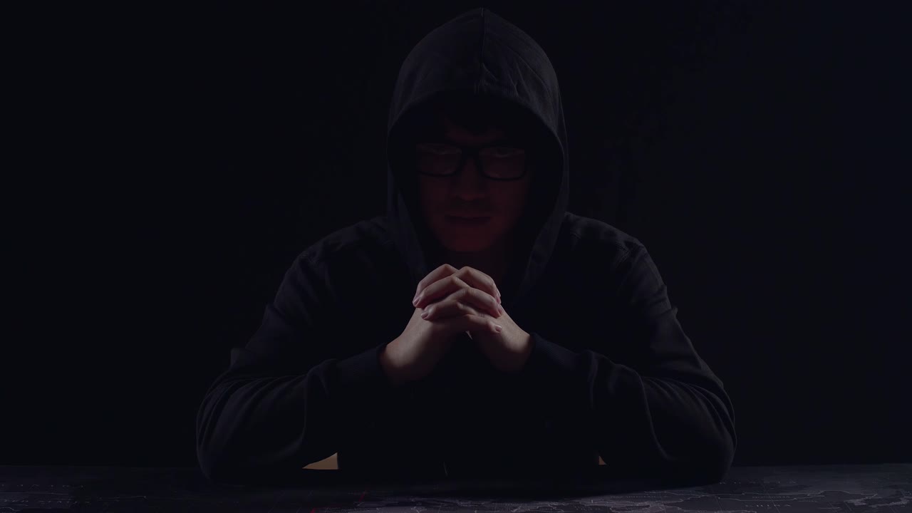 Mysterious Man With Hoodie On Black Background
