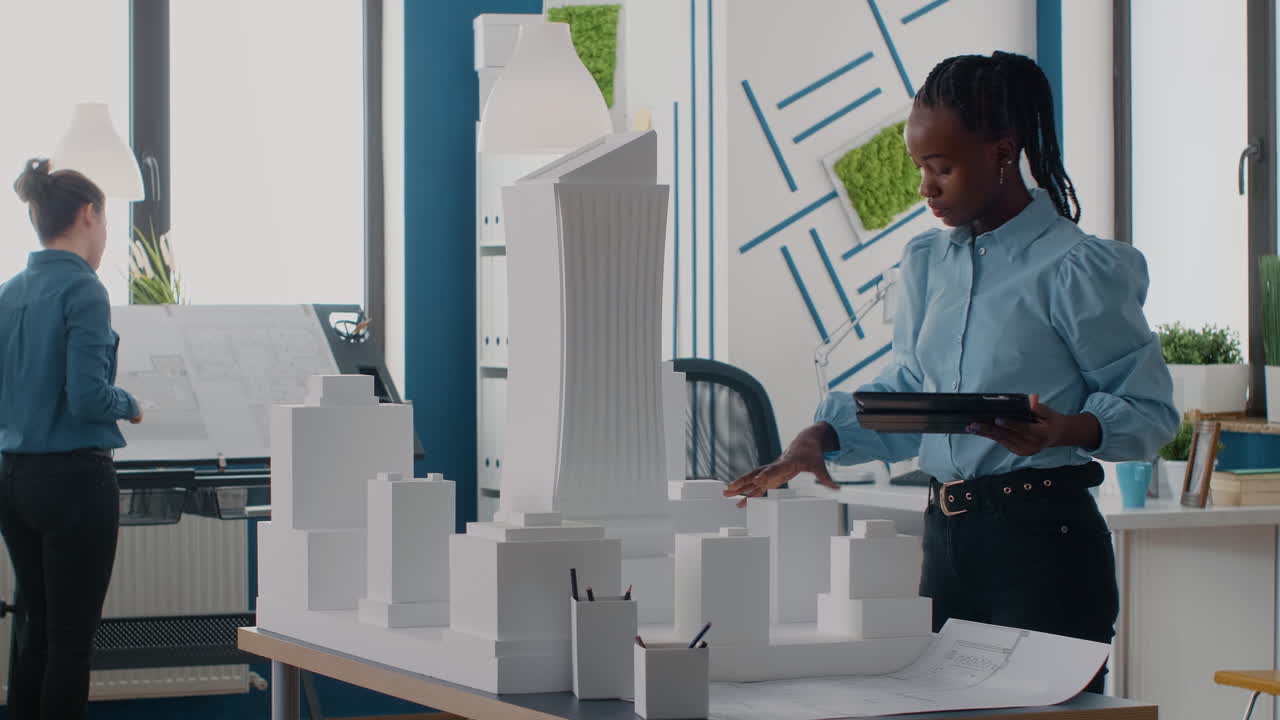 Architects working on a building model in an office