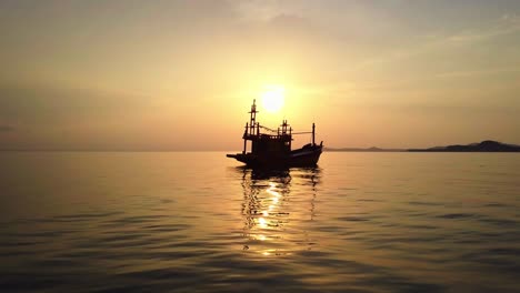 fishing boat at sea on sunset background