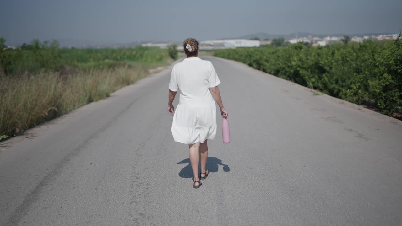 Woman Walking on a Country Road