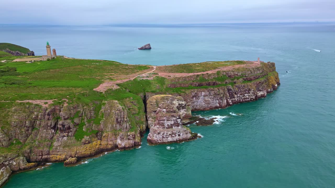 Cap Fréhel headland, lighthouse, cliffs, Brittany, France. Aerial drone lateral view