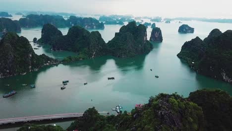 High-angle-footage-of-a-lady-sitting-on-a-metal-roof-overlooking-the-sea-and-rocks-in-thailand-during-a-cloudy-and-overcast-day