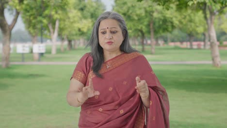 angry indian old woman shouting in park