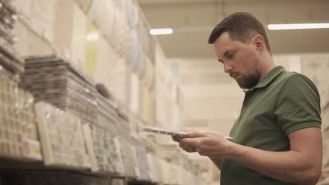 man shopping for tiles in a home improvement store