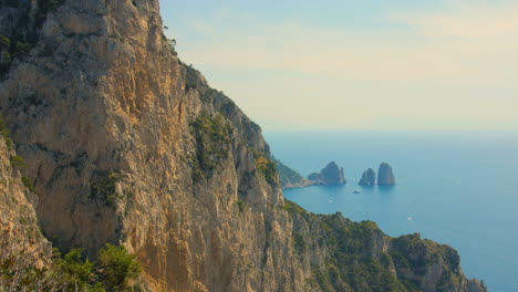 Aerial-tilt-down-shot-over-imposing-Monte-Solaro-Peak-on-the-island-of-Capri-in-Campania,-Italy-during-evening-time