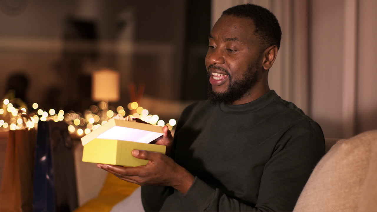 Man Excitedly Opening a Gift