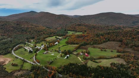 houses in the foothills of mountain with forest in autumn