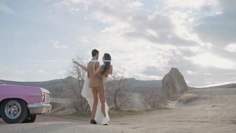 couple's romantic elopement in a pink car