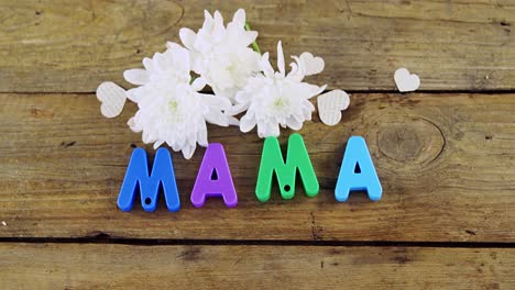 heart shape with alphabet reading mama and white flowers