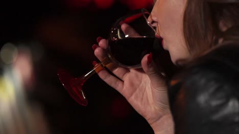 woman drinking wine at a bar