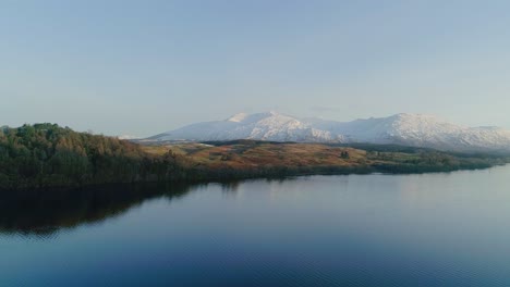 sunrise aerial shot of a snowy capped ben cruachan, a mountain in argyll and bute, scotland