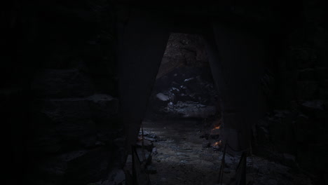 mysterious cave entrance surrounded by shadows and rocky terrain at dusk