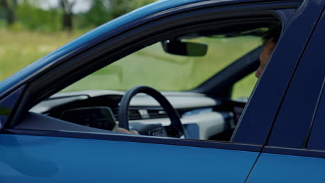 modern electric car rides through in cold blue style. stylish urban car riding on road.
