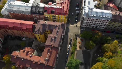 Aerial-view-of-colorful-buildings-on-street-with-parked-cars-in-city-center